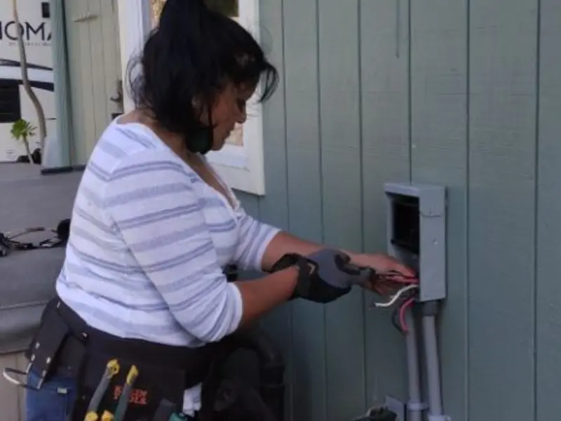 Licensed electrician wiring an exterior subpanel in Strathmore
